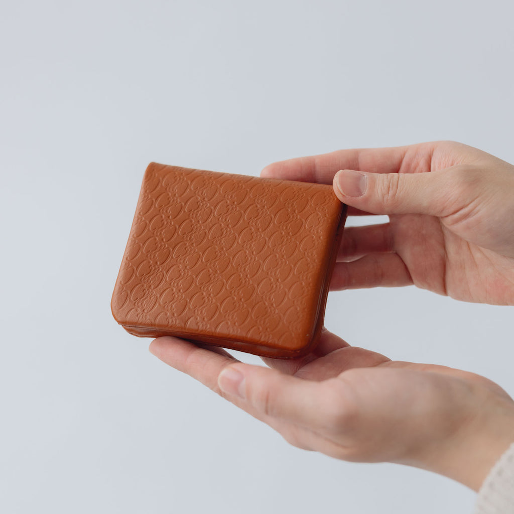 COSMIC WONDER monogram embossed light leather  bifold coin case